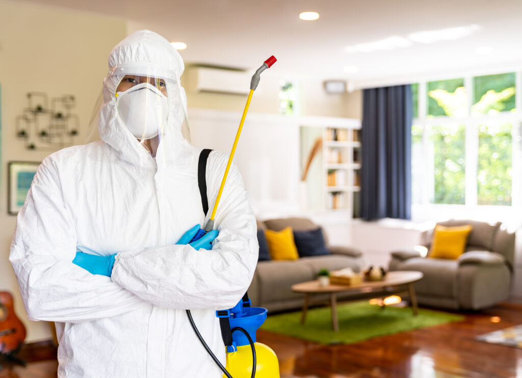 Asian man in PPE disinfection from COVID-19 at home